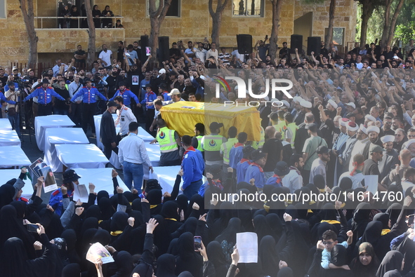 Lebanese clerics pray over the coffins of 16 people, including three Hezbollah militants, who are killed in an Israeli airstrike on the vill...