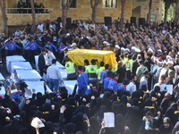 Lebanese clerics pray over the coffins of 16 people, including three Hezbollah militants, who are killed in an Israeli airstrike on the vill...