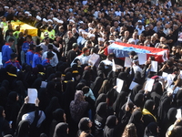 Lebanese clerics pray over the coffins of 16 people, including three Hezbollah militants, who are killed in an Israeli airstrike on the vill...