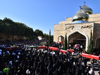 Lebanese clerics pray over the coffins of 16 people, including three Hezbollah militants, who are killed in an Israeli airstrike on the vill...