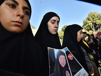 Lebanese clerics pray over the coffins of 16 people, including three Hezbollah militants, who are killed in an Israeli airstrike on the vill...