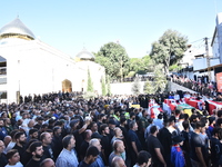 Lebanese clerics pray over the coffins of 16 people, including three Hezbollah militants, who are killed in an Israeli airstrike on the vill...