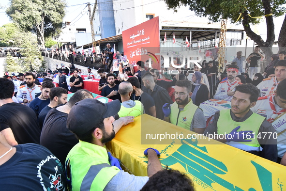 Lebanese clerics pray over the coffins of 16 people, including three Hezbollah militants, who are killed in an Israeli airstrike on the vill...