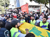 Lebanese clerics pray over the coffins of 16 people, including three Hezbollah militants, who are killed in an Israeli airstrike on the vill...