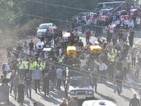 Lebanese clerics pray over the coffins of 16 people, including three Hezbollah militants, who are killed in an Israeli airstrike on the vill...