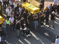 Lebanese clerics pray over the coffins of 16 people, including three Hezbollah militants, who are killed in an Israeli airstrike on the vill...