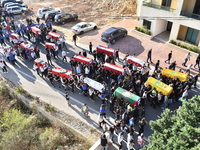 Lebanese clerics pray over the coffins of 16 people, including three Hezbollah militants, who are killed in an Israeli airstrike on the vill...