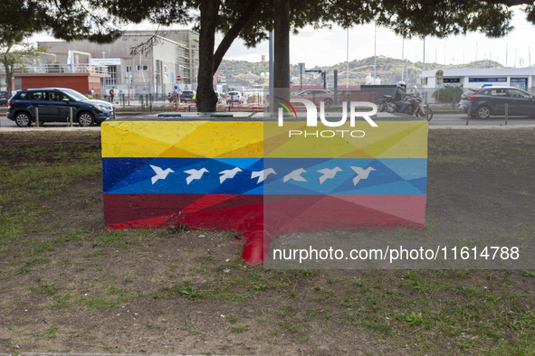 Cars drive by a Venezuelan flag painted by the street artist Flix Robotico in Lisbon, Portugal, on September 27, 2024. Data from the BdP ind...