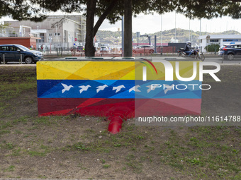 Cars drive by a Venezuelan flag painted by the street artist Flix Robotico in Lisbon, Portugal, on September 27, 2024. Data from the BdP ind...