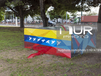 Cars drive by a Venezuelan flag painted by the street artist Flix Robotico in Lisbon, Portugal, on September 27, 2024. Data from the BdP ind...