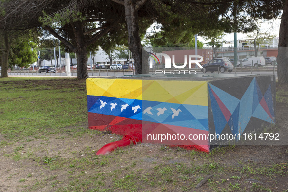 Cars drive by a Venezuelan flag painted by the street artist Flix Robotico in Lisbon, Portugal, on September 27, 2024. Data from the BdP ind...