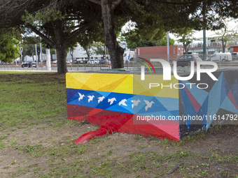 Cars drive by a Venezuelan flag painted by the street artist Flix Robotico in Lisbon, Portugal, on September 27, 2024. Data from the BdP ind...