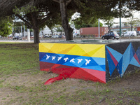 Cars drive by a Venezuelan flag painted by the street artist Flix Robotico in Lisbon, Portugal, on September 27, 2024. Data from the BdP ind...