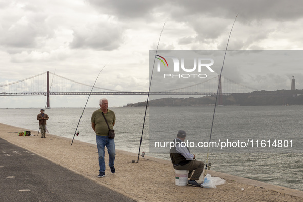 A general view of people fishing at the Tejo River in Lisbon, Portugal, on September 27, 2024. Data from the BdP indicate that revenue from...