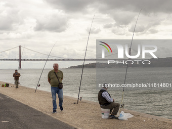 A general view of people fishing at the Tejo River in Lisbon, Portugal, on September 27, 2024. Data from the BdP indicate that revenue from...