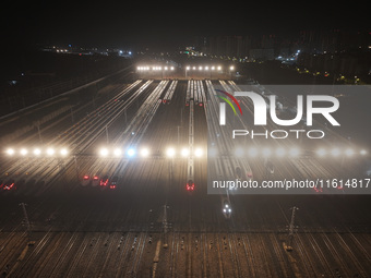 Bullet trains stop at the Nanjing South Railway station in Nanjing, China, on September 28, 2024. China's railways are expected to carry 175...