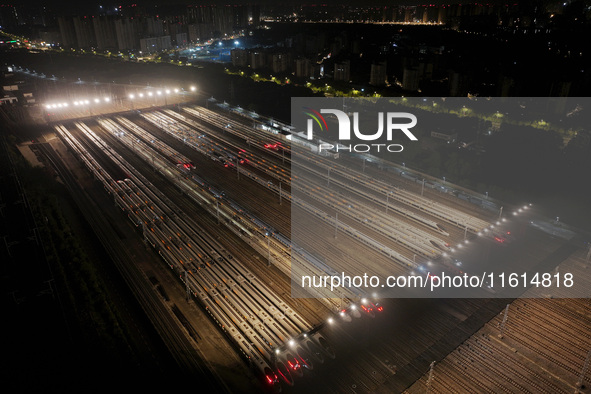 Bullet trains stop at the Nanjing South Railway station in Nanjing, China, on September 28, 2024. China's railways are expected to carry 175...