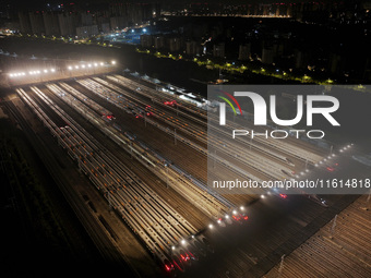 Bullet trains stop at the Nanjing South Railway station in Nanjing, China, on September 28, 2024. China's railways are expected to carry 175...