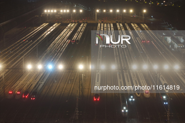 Bullet trains stop at the Nanjing South Railway station in Nanjing, China, on September 28, 2024. China's railways are expected to carry 175...