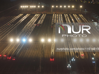 Bullet trains stop at the Nanjing South Railway station in Nanjing, China, on September 28, 2024. China's railways are expected to carry 175...