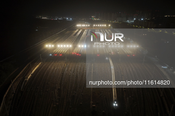 Bullet trains stop at the Nanjing South Railway station in Nanjing, China, on September 28, 2024. China's railways are expected to carry 175...