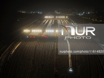 Bullet trains stop at the Nanjing South Railway station in Nanjing, China, on September 28, 2024. China's railways are expected to carry 175...