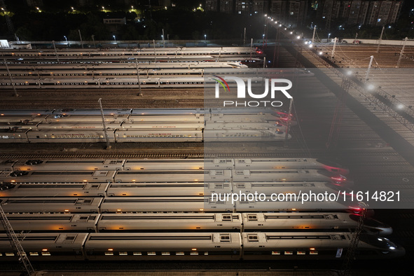 Bullet trains stop at the Nanjing South Railway station in Nanjing, China, on September 28, 2024. China's railways are expected to carry 175...