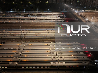 Bullet trains stop at the Nanjing South Railway station in Nanjing, China, on September 28, 2024. China's railways are expected to carry 175...