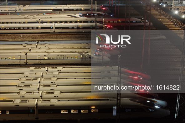 Bullet trains stop at the Nanjing South Railway station in Nanjing, China, on September 28, 2024. China's railways are expected to carry 175...