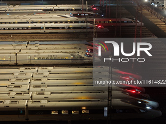 Bullet trains stop at the Nanjing South Railway station in Nanjing, China, on September 28, 2024. China's railways are expected to carry 175...