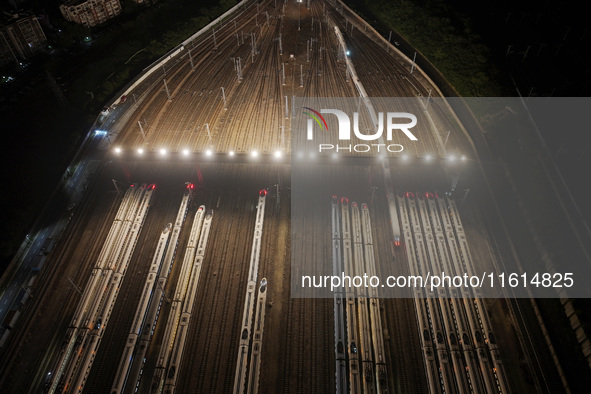 Bullet trains stop at the Nanjing South Railway station in Nanjing, China, on September 28, 2024. China's railways are expected to carry 175...