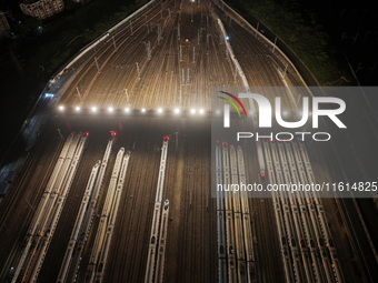 Bullet trains stop at the Nanjing South Railway station in Nanjing, China, on September 28, 2024. China's railways are expected to carry 175...