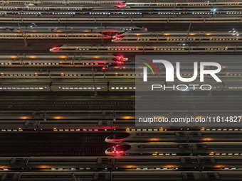 Bullet trains stop at the Nanjing South Railway station in Nanjing, China, on September 28, 2024. China's railways are expected to carry 175...