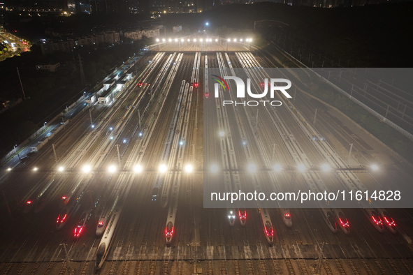 Bullet trains stop at the Nanjing South Railway station in Nanjing, China, on September 28, 2024. China's railways are expected to carry 175...