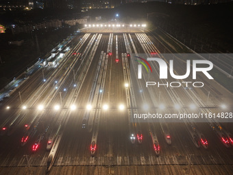 Bullet trains stop at the Nanjing South Railway station in Nanjing, China, on September 28, 2024. China's railways are expected to carry 175...