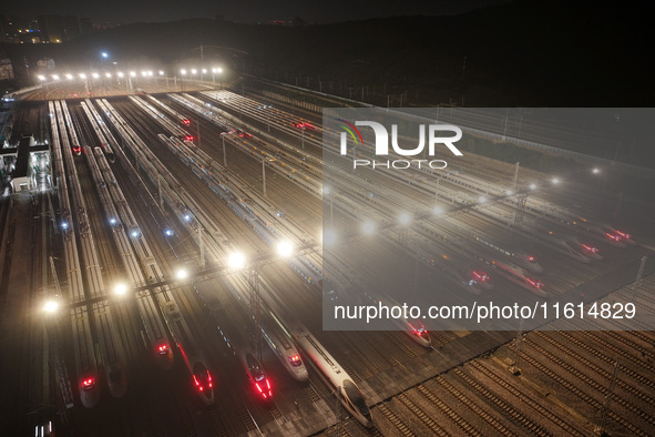 Bullet trains stop at the Nanjing South Railway station in Nanjing, China, on September 28, 2024. China's railways are expected to carry 175...