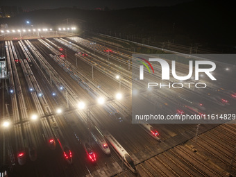 Bullet trains stop at the Nanjing South Railway station in Nanjing, China, on September 28, 2024. China's railways are expected to carry 175...