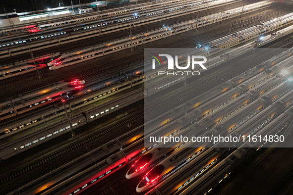 Bullet trains stop at the Nanjing South Railway station in Nanjing, China, on September 28, 2024. China's railways are expected to carry 175...