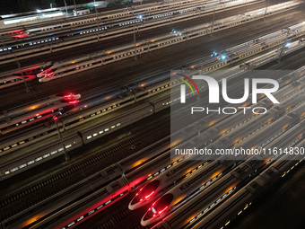 Bullet trains stop at the Nanjing South Railway station in Nanjing, China, on September 28, 2024. China's railways are expected to carry 175...