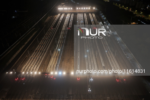 Bullet trains stop at the Nanjing South Railway station in Nanjing, China, on September 28, 2024. China's railways are expected to carry 175...