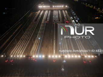 Bullet trains stop at the Nanjing South Railway station in Nanjing, China, on September 28, 2024. China's railways are expected to carry 175...