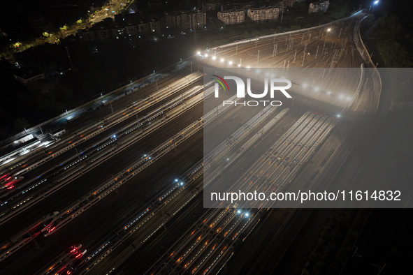 Bullet trains stop at the Nanjing South Railway station in Nanjing, China, on September 28, 2024. China's railways are expected to carry 175...