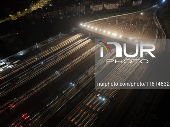 Bullet trains stop at the Nanjing South Railway station in Nanjing, China, on September 28, 2024. China's railways are expected to carry 175...