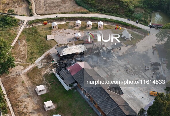 A hotel house is engulfed by fire in Xindian town, Tongren, China, on September 27, 2024. 