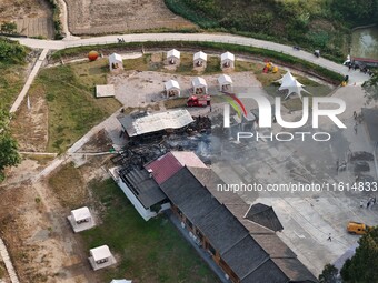 A hotel house is engulfed by fire in Xindian town, Tongren, China, on September 27, 2024. (