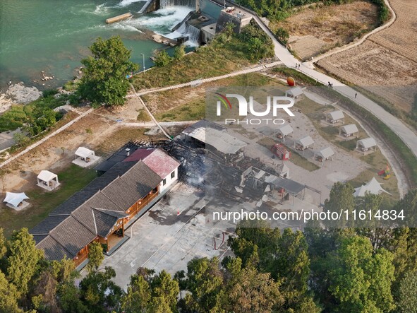 A hotel house is engulfed by fire in Xindian town, Tongren, China, on September 27, 2024. 