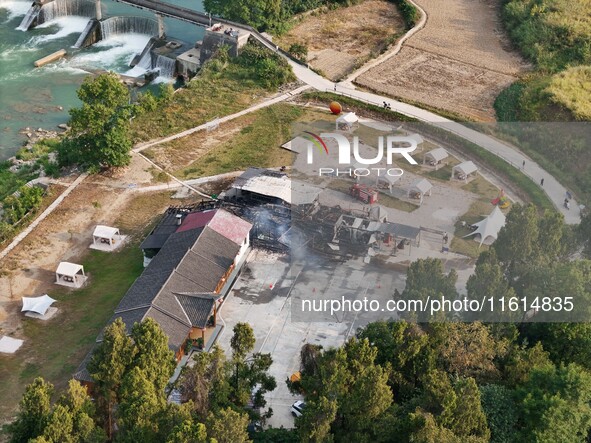 A hotel house is engulfed by fire in Xindian town, Tongren, China, on September 27, 2024. 