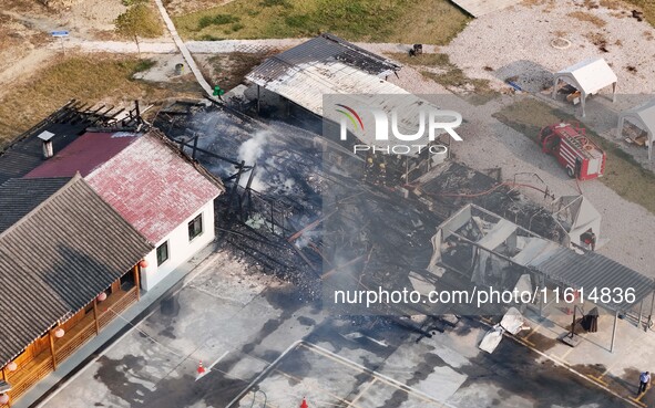 A hotel house is engulfed by fire in Xindian town, Tongren, China, on September 27, 2024. 