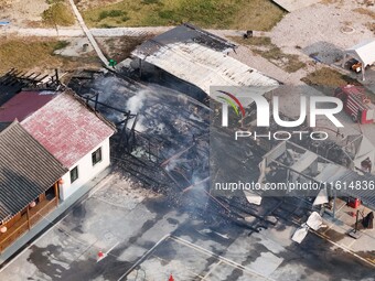 A hotel house is engulfed by fire in Xindian town, Tongren, China, on September 27, 2024. (