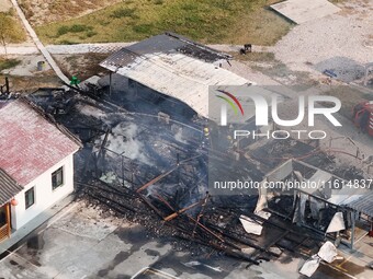 A hotel house is engulfed by fire in Xindian town, Tongren, China, on September 27, 2024. (